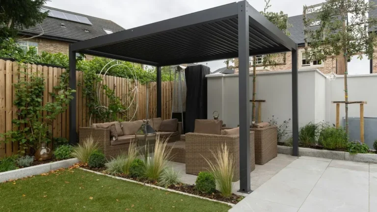 The Trick Landscape Designers Use to Make a Louvered Pergola Look Like It Grew There - Featured image