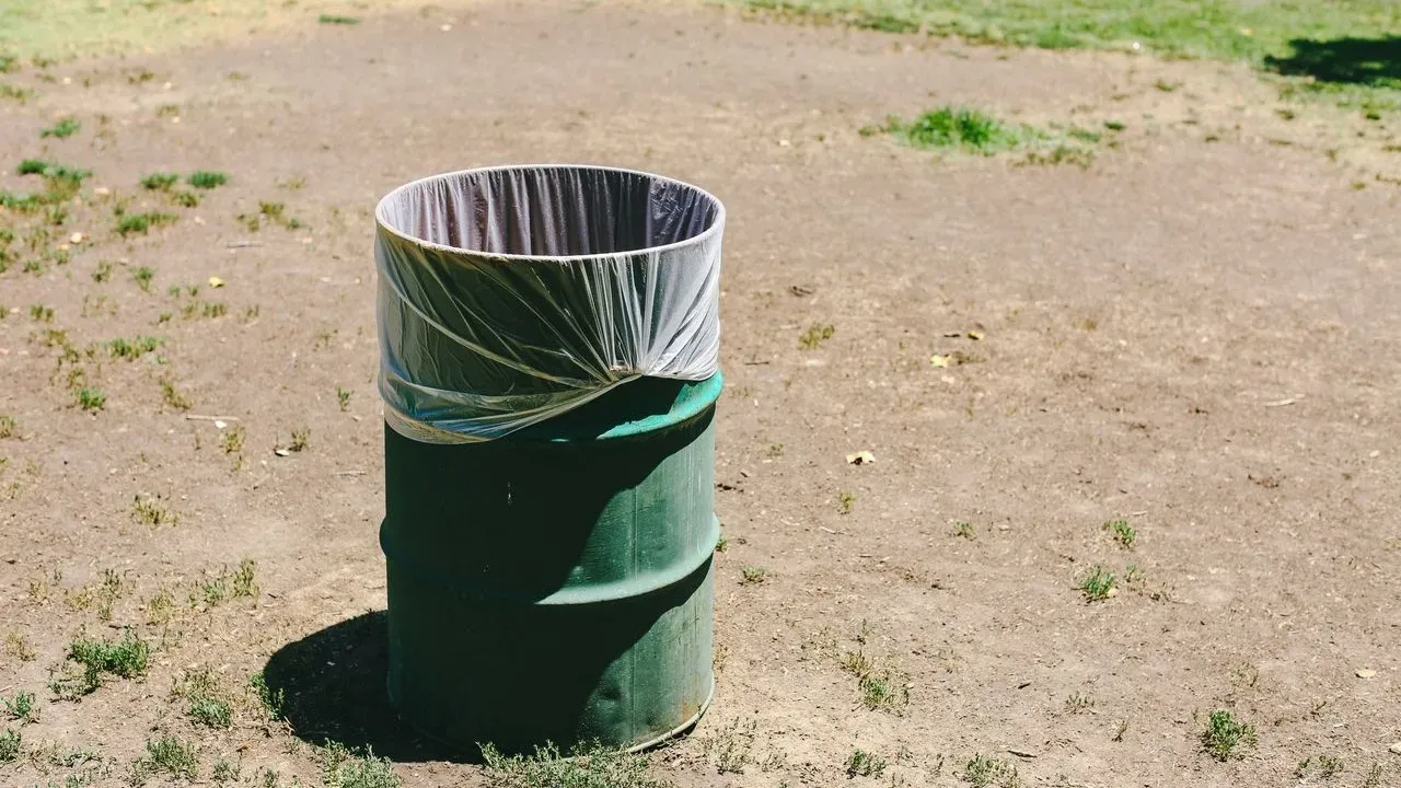 The Genius Backyard Trick Gardeners Use to Make Trash Cans Vanish